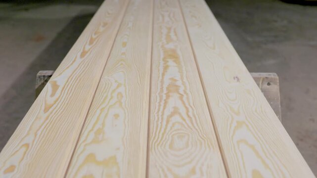Detailed view of pine wood planks showcasing natural grain patterns and smooth finish, arranged in parallel with visible copy space