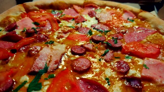 Fresh Hot Meat Pizza with Salami, Ham and Tomatoes. Delicious Italian Fast Food 