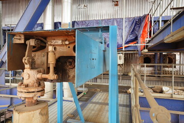 Inside a bustling industrial facility, showcasing complex heavy machinery, pipes, and robust infrastructure used for manufacturing and processing raw materials in a large-scale production environment