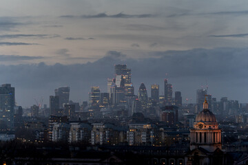 Dusk cityscape with illuminated buildings