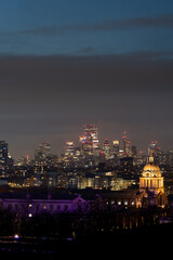 City skyline at dusk with glowing lights