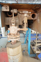 Industrial Machinery Component with Valves and Pipes in a Factory Setting