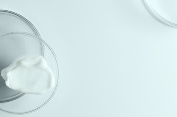 Moisturizing cosmetic skin cream in a Petri dish. Copy space