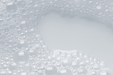 Bubbles of body gel or soap foam or shaving gel. Closeup. Copy space
