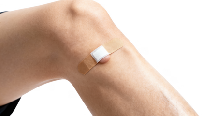 Applying medical tape over a small sterile dressing on adult leg lump showcasing precise and safe bandage placement against clean white background.