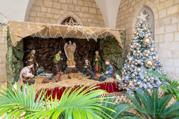 Obraz premium Christmas nativity scene before Christmas Mary and Joseph by the manger in the inner courtyard of the Latin Patriarchate of Jerusalem in the Old City of Jerusalem.Israel