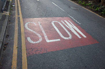 Road marking SLOW on pavement