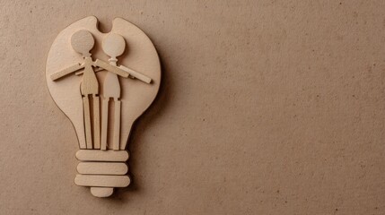 Two wooden human figures stand close together forming a light bulb shape,