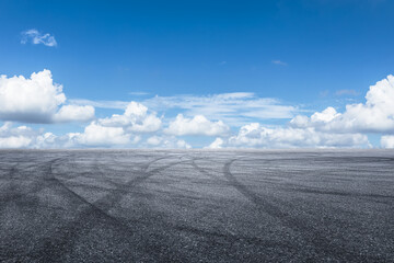 Empty asphalt road and blue sky with clouds background. © zhao dongfang