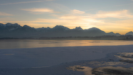 Fototapeta premium Sunset on Lake Hopfen in Bavaria Germany in Winter 2025 - Beautiful Alps with Great LIght and Ice. High quality photo