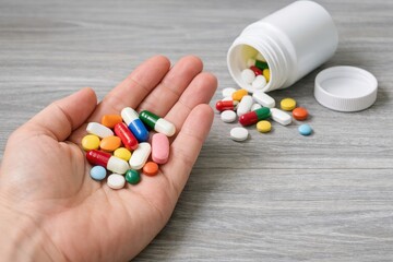 Colorful pills and medicines held in the hand
