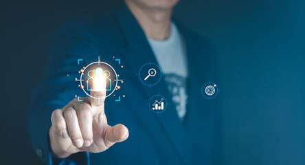 Business professional touching virtual people icon on digital interface, representing human resources management, customer targeting, data analysis, recruitment strategy, and modern business technolog