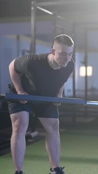 Fitness man train swiss bar row weightlifting exercise in gym