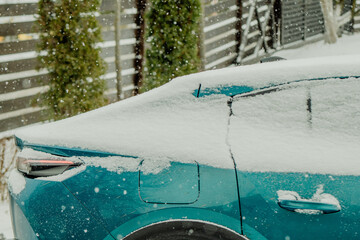 Brushing Snow Off a Car Windshield in Winter