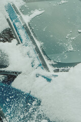 Brushing Snow Off a Car Windshield in Winter