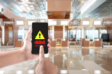 Human hand holding a smartphone displaying a 404 error message with a blurred background. The image symbolizes connection issues, lost information, and the frustrations of digital technology