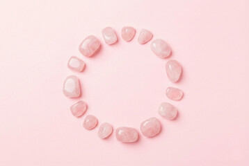Pink stones arranged in circle on pastel background
