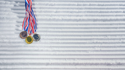 golden medal on the textured ski slopes in the snow - winter sport successful concept. Skiing, biathlon.