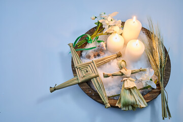 Imbolc altar with brigid cross and doll, celebrating spring