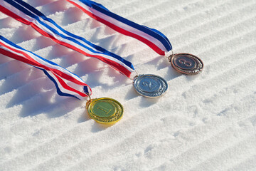 golden medal on the textured ski slopes in the snow - winter sport successful concept. Skiing,...