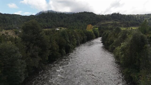 Aerial Rising Shot from River to Rural Settlement and Valley