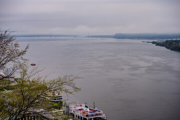 Ferries docked on the St. Lawrence River with bridge in the distance