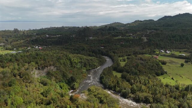 Fast Aerial Descent Towards River in Valley Between Forests