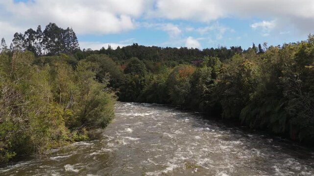 Aerial View Flying Downstream Over Turbulent River Current