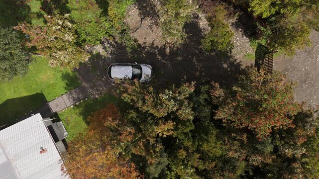 Aerial Overhead View of House Yard and Parked Car in Rural Landscape