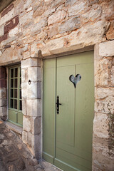 Facade of a stone typical and rustic French house