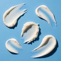 Creamy Swatches on Blue Surface - Skincare Product Texture.