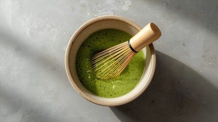 Traditional Japanese bamboo matcha whisk chasen on stone surface with minimalist background