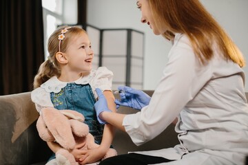 Smiling child receiving vaccination from medical professional for health