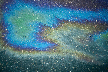 Iridescent oil slick creating colorful rainbow abstract pattern