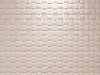 Fototapeta premium Seamless geometric white wall surface with repeating textured three-dimensional square panels pattern, creating subtle depth and soft shadows, ideal for interior design and 3D max rendering software.