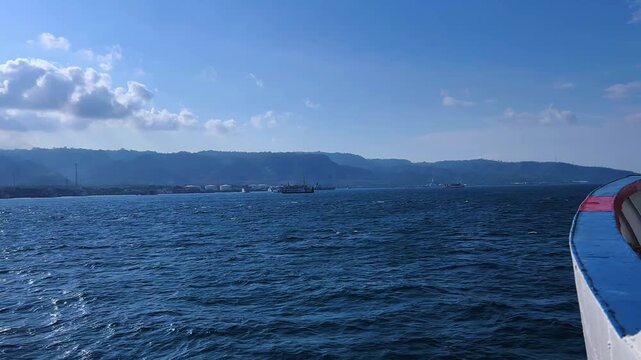 Bali, Indonesia - August 27, 2025: Car and passenger ferries cross the Bali Strait from Gilimanuk Harbor to Ketapang Harbor. View of the strait from the ferry deck. 4К