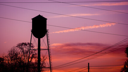 Water tower, power lines and fiery sunset in South Carolina