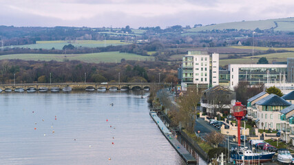 Aerial view of Avoca Bridge and modern Arklow riverfront with new buildings and Wicklow hills rising in the distance. © Vitaliy