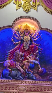Goddess Durga in her powerful Mahishasura Mardini form, depicted with multiple arms holding sacred weapons