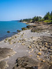 Rocky rugged coast of the Bay of Fundy at the Black Rock Lighthouse on the western side of Nova Scotis Canada