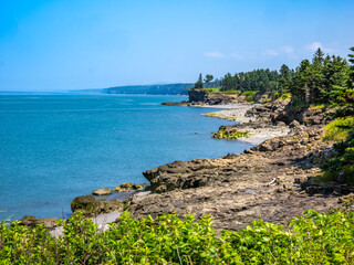 Rocky rugged coast of the Bay of Fundy at the Black Rock Lighthouse on the western side of Nova Scotis Canada
