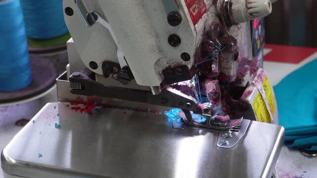Interlock or overlock sewing machine in operation closeup