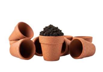 Miniature unglazed terracotta seedling pots, one filled with rich dark soil, others scattered, sharp macro focus on porous texture, isolated on high-key white background with bokeh. Concept of