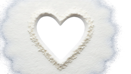 A white powdery substance forms a heart shape with a dark void at its center