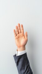 Businessman Raising Hand with Hawk Head in Professional Attire Against Minimalist Background