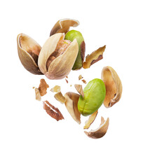 Fresh pistachios breaking open with scattered shells on a dark background isolated on transparent background
