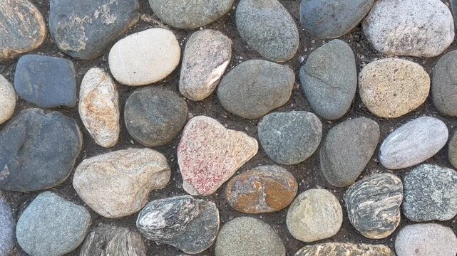 Top view of smooth natural river pebbles and stones texture background