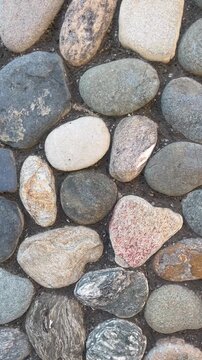 Top View of Natural River Stones and Smooth Pebbles Texture Background