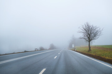 a car on the freeway in the heavy fog
