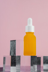 Cosmetic product in tube, bottle, lotion or serum with stylish props on pink background. 